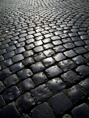 15556225-many-streets-in-rome-italy-are-paved-with-cobblestones